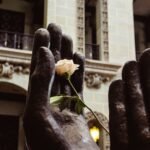 a statue of a hand holding a rose