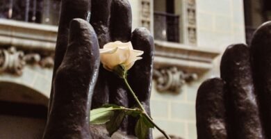 a statue of a hand holding a rose