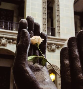 a statue of a hand holding a rose